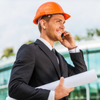 Man in hard hat holds construction plans