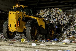 A bulldozer compacts plastic in a recycling plant